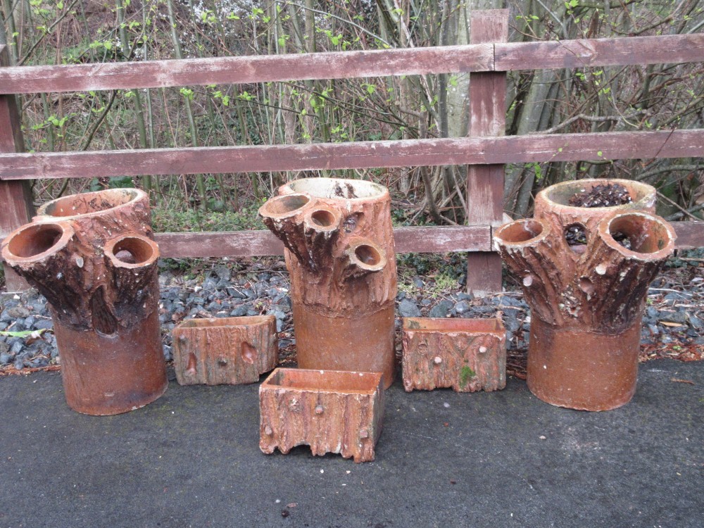 A set of three terracotta Planters moulded as a tree trunk, 2ft H, and a set of three rectangular