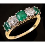 An Emerald and Diamond five stone Ring claw-set three graduated step-cut emeralds interspersed