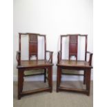 A pair of provincial Chinese stained elm Armchairs, shaped top rails with solid splats carved with