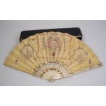A 19th Century bone Fan having pierced guards with gilt detail and vellum leaf painted vignettes