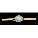 An Opal and Diamond Cluster Bar Brooch set oval opal cabochon within a frame of old-cut millegrain-