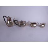 An Edward VII silver four piece Tea and Coffee Service of semi-fluted oblong form on ball feet,