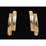 A pair of Diamond Earrings each channel-set a column of calibre-cut stones, stamped 14K