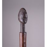 A Mende Staff, Sierra Leone, the finial carved as a head with pointed coiffure, 39in. L