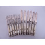 Six Victorian Dessert Knives and Forks with silver mounts and blades, the mother of pearl hafts with