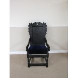 An antique oak Armchair with scroll carved cresting rail, diamond carved panel back, later blue