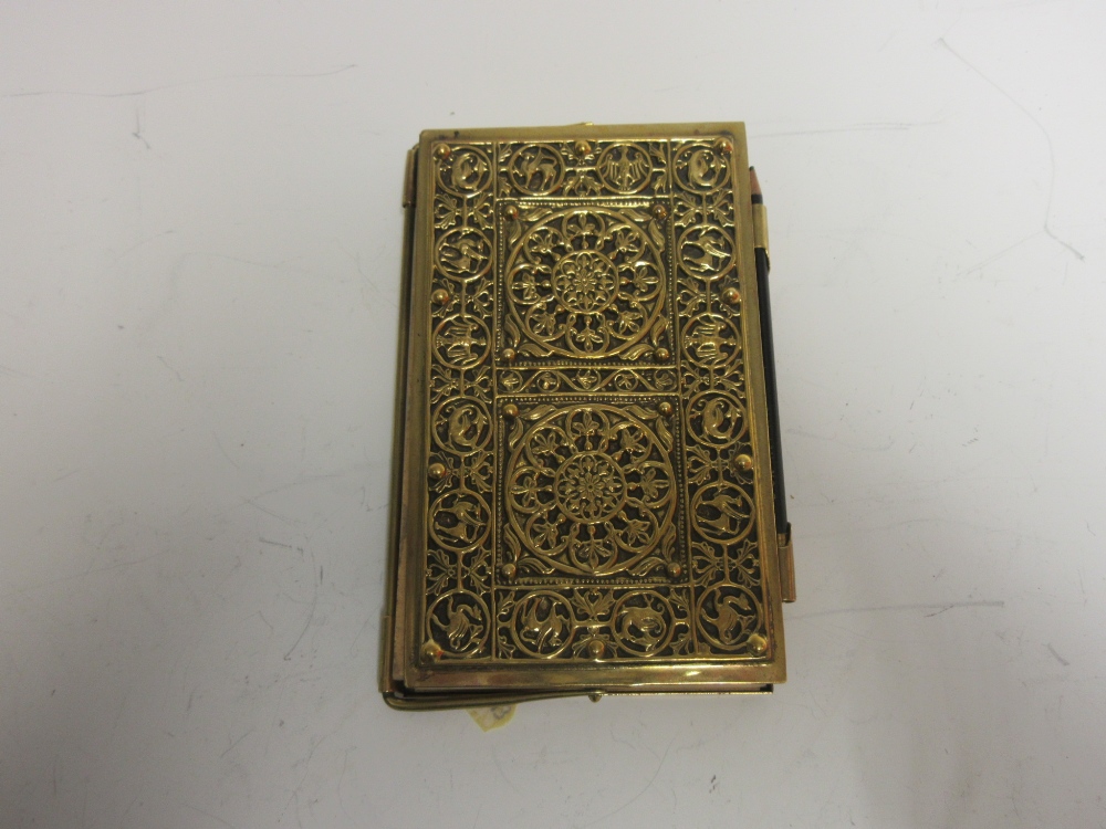 A brass cased Bridge Score Book with embossed front cover of rosette design surrounded by a border