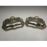 A pair of George V silver shaped oblong Entrée Dishes and Covers with gadroon rims, engraved coats