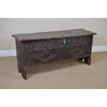 An early 17th Century oak Plank Coffer, the hinged top with remnants of red paint, the front