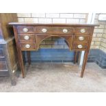 A late Georgian mahogany Dressing Table with satinwood stringing fitted seven small drawers on