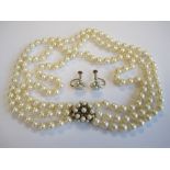 A three strand Cultured Pearl Choker on cluster clasp set cultured pearls in 9ct gold together