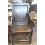 An 18th Century oak Wainscot Chair, the shaped crest rail above a fielded panel back and downswept