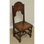 A 17th Century oak Side Chair with plain deep arched splat having acorn finial, solid seat on turned