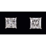 A pair of Diamond Ear Studs each corner claw-set princess-cut stone, 1.26cts and 1.28cts