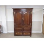 An 18th Century oak Hall Cupboard with pair of cupid's bow panelled doors enclosing hanging space,