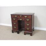 A Georgian mahogany Kneehole Desk, fitted frieze drawer, three drawers to each side and small drawer