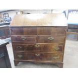 An 18th Century walnut Bureau, the string inlaid fall enclosing a stepped and welled interior of