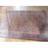 A bordered Persian Rug with herati pattern on a blue ground, the principal border with palmette