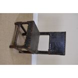 A 17th Century oak Child's Chair in the Cromwellian style with studded leather back and seat on