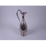A Victorian silver Claret Jug with scroll engraving and vacant cartouche, beaded rim, hinged cover