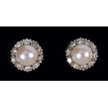A pair of Cultured Pearl and Diamond Cluster Earrings each millegrain-set pearl within a frame of