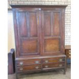 An 18th Century oak Hall Cupboard with dentil frieze above pair of solid panelled doors enclosing