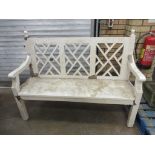 A white painted Garden Bench with lattice panelled back, shaped arms and ball finials, 4ft 10in W