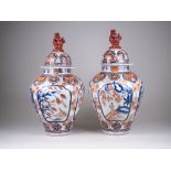 A pair of Japanese Imari Vases and Covers, ovoid bodies decorated with panels of quail and