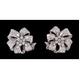 A pair of Diamond flower Cluster Earrings each claw-set seven brilliant-cut stones within pavé-set