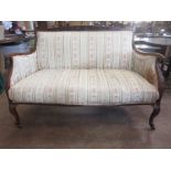 An Edwardian French style Settee with striped floral upholstery on cabriole legs