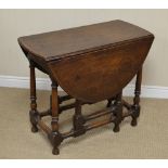 An 18th Century oak oval Gate-leg Table on gun barrel turned and square legs united by turned and