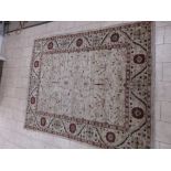 A Persian Carpet with floral motifs on a camel ground, 10ft x 7ft 10in