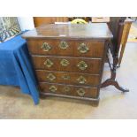 An 18th Century walnut Chest of Drawers, the quartered moulded top above four long drawers flanked