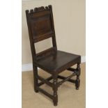 A 17th Century oak Side Chair with shaped top rail, scratch carved frieze, plain fielded panel back,