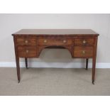 A late Georgian mahogany Dressing Table with cross-banded top above five short drawers on square