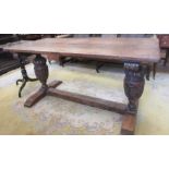 A Jacobean style Dining Table, the twin plank top above carved cup and cover legs on sledge H