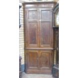 An antique oak Double Corner Cupboard with two pairs of solid panelled doors
