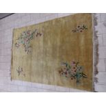 A Chinese Carpet decorated flowering branches on a gold ground, 10ft 3in x 6ft 11in