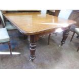 A Victorian oak extending Dining Table with three spare leaves on turned supports with ceramic