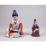 A Japanese Kutani seated female Figure, Meiji Period, wearing a Shinto cap and reading a makemono, 8