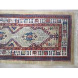 A bordered Persian Runner with geometric design on a camel ground, 14ft x 2ft 8in