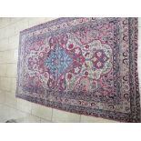 A bordered Kashan Rug with floral medallions and corner design in pink and camel, 6ft 9in x 4ft 5in,