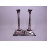 A pair of George II silver Pillar Candlesticks with fluted columns, pierced corinthian capitals on