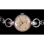 A Lady's mid 20th Century Rolex Wristwatch, the champagne dial with alternating arabic numerals