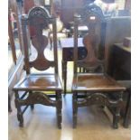 A pair of 18th Century carved oak Side Chairs, the pierced top rails above a shaped splat and