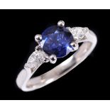 A Sapphire and Diamond three stone Ring claw-set round sapphire, 1.53cts, between two pear-cut