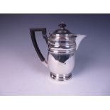 A Victorian silver Hot Water Jug of baluster form with reeded bands, London 1898