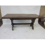 A 17th Century style oak Dining Table, rectangular top on trestle end supports, wedge and peg