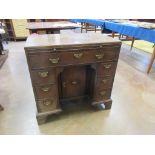 An 18th Century mahogany kneehole Dressing Table, the moulded caddy top above a brushing slide,