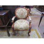 A pair of Victorian oak and pollard oak Elbow Chairs with floral upholstered backs, arms and